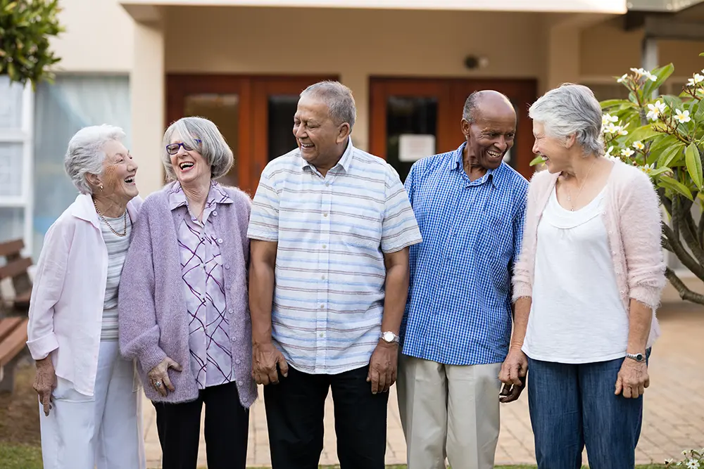 Group of older adults enjoying social activities in a senior care setting