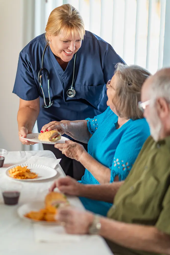 Healthcare provider assisting senior adults with care and support services