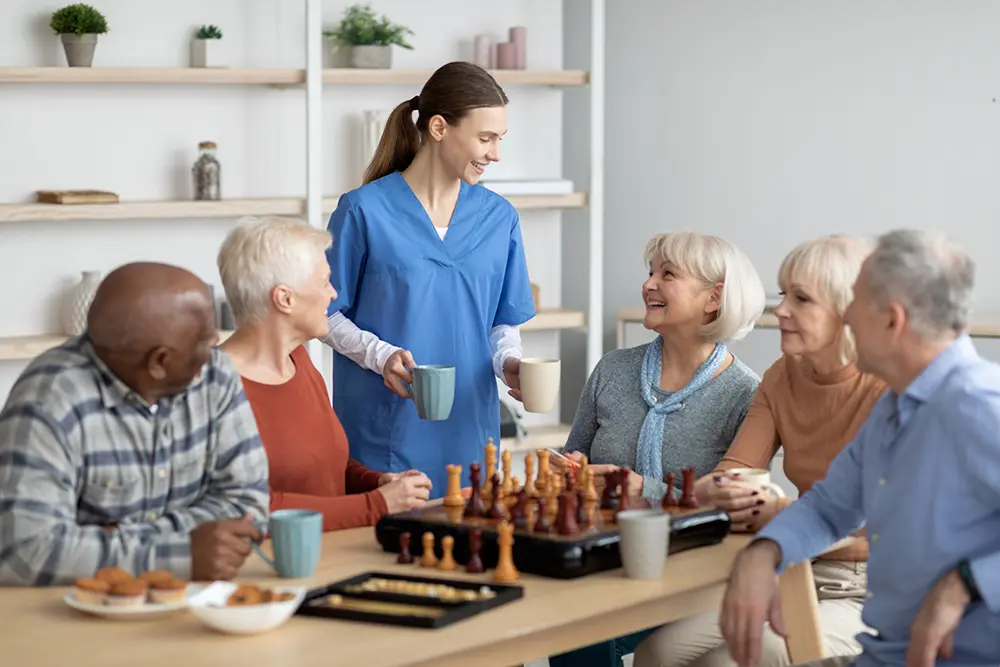 Caregiver sharing a conversation with older adults during a senior support visit